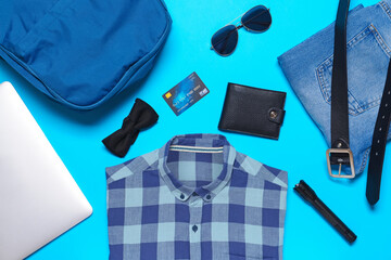 Set of travel accessories for men on color background