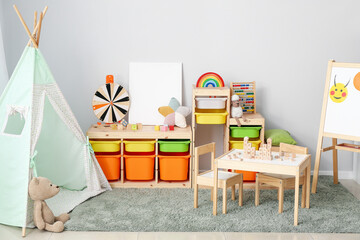 Interior of modern children's room with play tent and toys
