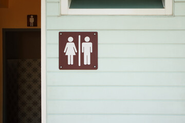 entrance of public toilet with man and lady restroom sign / background with space for text or image
