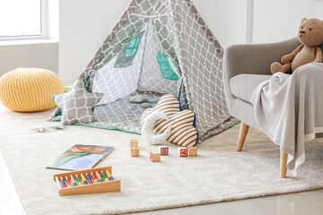 Interior of modern children's room with play tent and toys