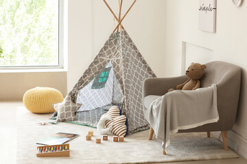 Interior of modern children's room with play tent and toys © Pixel-Shot