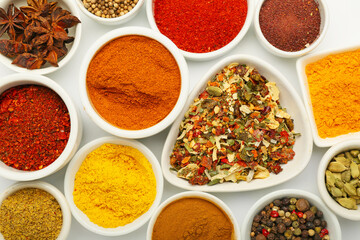 Bowls with different aromatic spices on white background