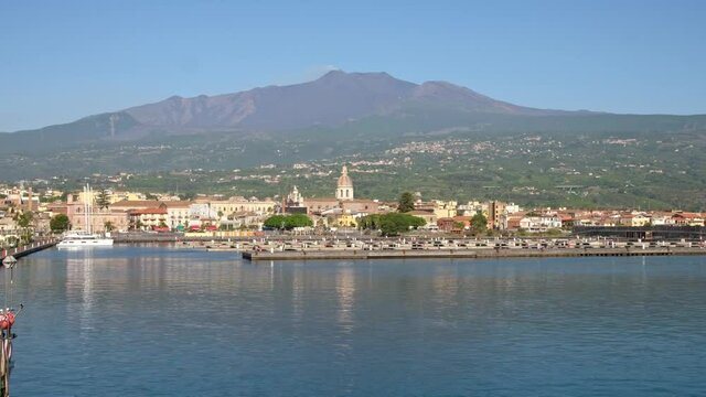 The marina of Riposto town with volcano Etna at background in Sicily
