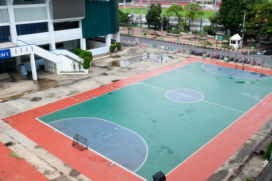 Colourful sports court background. Top view to red and blue field ground with white and yellow lines outdoors
