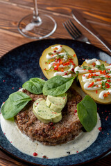 Appetizing photo for a menu of a grilled pork chop with aroma herbal butter and potato, stylish rustic style