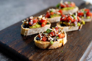 Bruschetta Sandwich served as an appetizer with tomato, avocado, onion and balsamic glaze