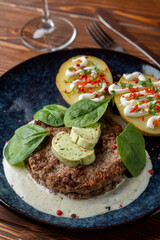 Appetizing photo for a menu of a grilled pork chop with aroma herbal butter and potato, stylish rustic style
