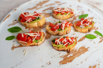 Bruschetta Sandwich served as an appetizer with tomato, avocado, onion and balsamic glaze