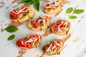 Bruschetta Sandwich served as an appetizer with tomato, avocado, onion and balsamic glaze