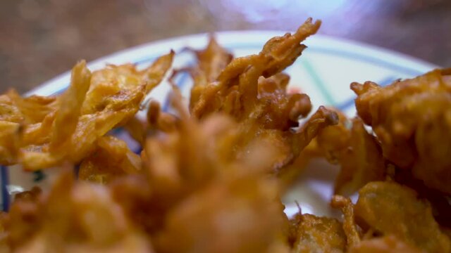 Crispy Golden Brown Fried Onion (Onion Pakoda) With Mint Sauce On A Plate In India. - Macro Shot 