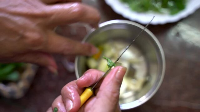 Slicing Raw Mangoes And Chili Using Small Kitchen Knife. - Close Up Shot