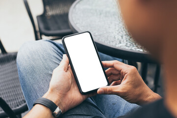 cell phone mockup blank white screen.man hand holding texting using mobile on desk at coffee shop.background empty space for advertise.work people contact marketing business,technology