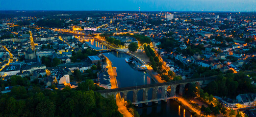 Evening aerial view of Laval with buildings, river Mayenne and old bridge, Mayenne department,...