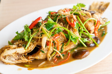 deep fried sea bass fish with sweet sauce and trimmings