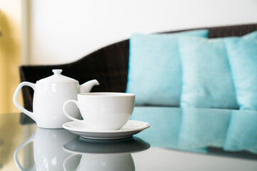 tea cup with teapot on table