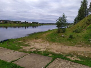 Old white boat on the river bank in summer,Russia
