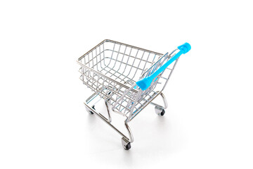 Sale background. Empty trolley cart for supermarket isolated on white background. Food shopping basket for retail market. Discount promotion and Black Friday concept. Copy space for text.
