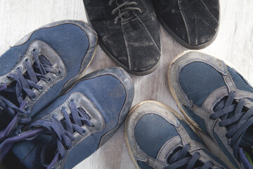 Old dirty shoes on the white table.