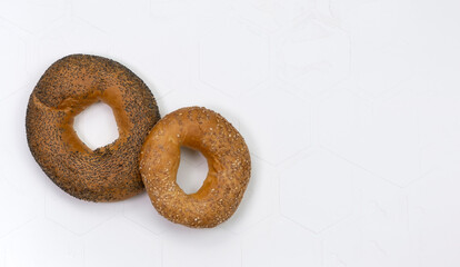 Fresh breakfast bread bagel roll with seeds isolated on white background