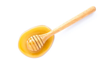 wooden spoon with honey on white.