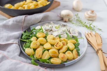 home made gnocchi with mushrooms and arugula salad