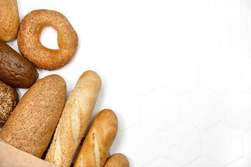 Different kinds of fresh bread on light background