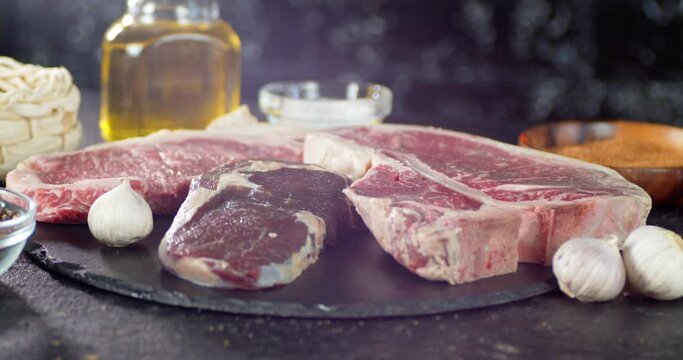 Pieces of raw beef with garlic and oil slowly rotate.
