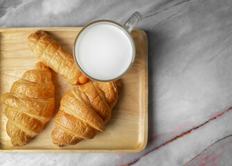 Top view Croissants and milk on marble background.