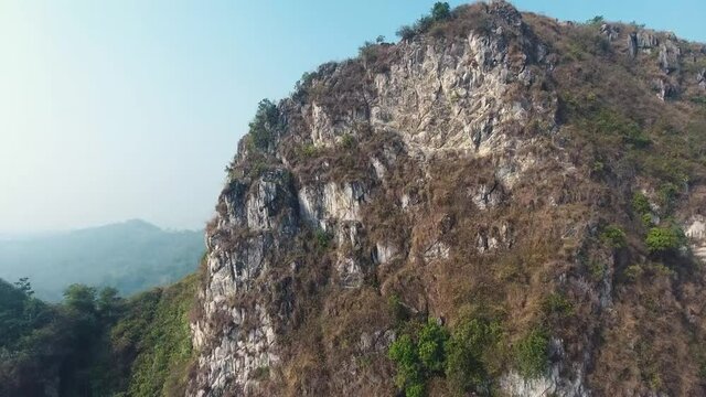 Huge epic tropical mountain rock with greens in summer HD Stock Footage Video