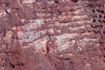 Close-up of red mining levels at iron ore quarry. Open-cast mine, open pit. Background, texture