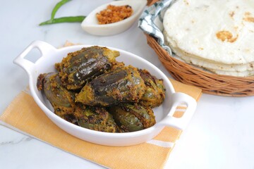 Indian, Maharashtrian side dish or appetizer Bharli Vangi, stuffed Eggplants, Crispy brinjal fry, Aubergine stuffed, served with Rice flour bhakri. copy space