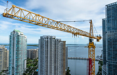 Crane against miami skyline building a skyscraper high rise in downtown 