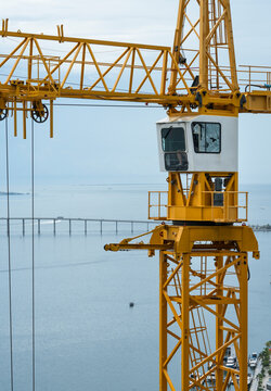 Crane towers above skyscraper construction site in downtown miami next to biscayne bay and key biscayne and brickell