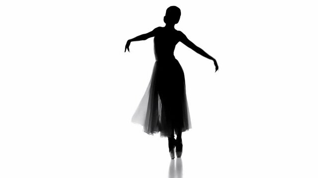 Silhouette of elegant ballerina dancing on pointe isolated on white