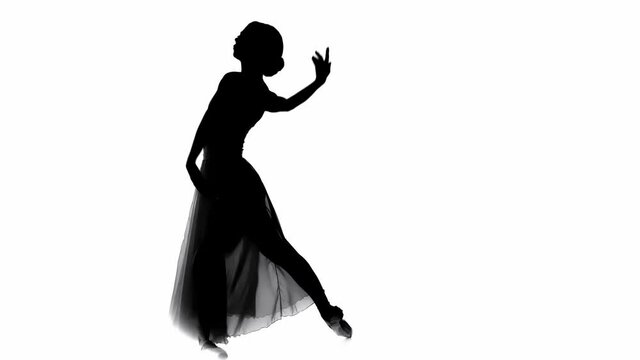 Silhouette of ballerina performing classical ballet moves isolated on white
