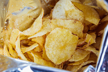 Traditional potato chips in bag. Fast food concept.