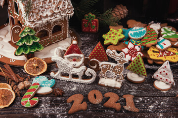 New year 2021, xmas and christmas theme: holiday gingerbreads on wooden background