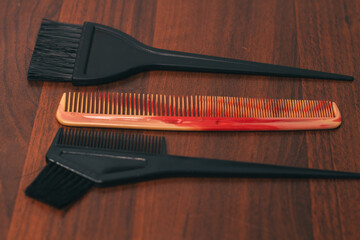 Plastic hair comb and black hair coloring brushes