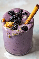 Berry smoothie with peanut butter and hemp seeds in glass. Healthy vegan food concept.