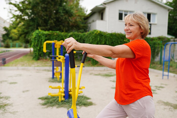 beautiful healthy woman 58 years old doing exercises outdoors