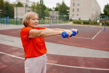 beautiful mature woman working out in the open air