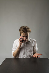 Angry young man on the phone.