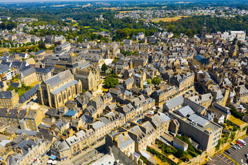 Scenic aerial view of summer cityscape of Dinan overlooking Gothic building of Catholic Church of Saint Malo, France - obrazy, fototapety, plakaty