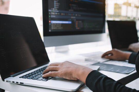 Professional development programmer cooperating meeting programming website working a software in office room.