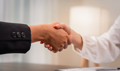 Close up of partnership handshake successful after negotiating business.