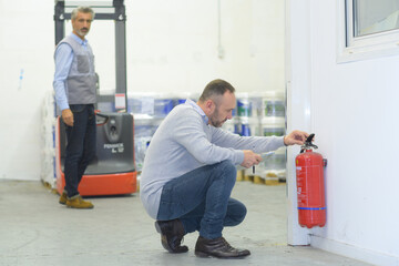 professional checking a fire extinguisher