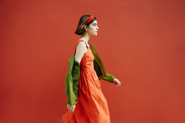 Red and green fancy clothes stylish girl walking. Looking side. profile. purposefully go to the...
