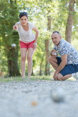 man and woman playing petanque