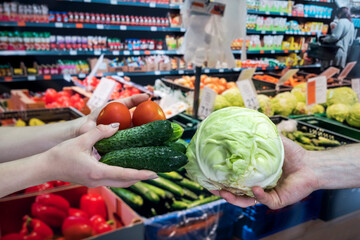 seller gives vegetables to the buyer in the store. the concept of shopping and a healthy lifestyle
