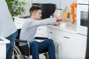 young handicapped man in the kitchen